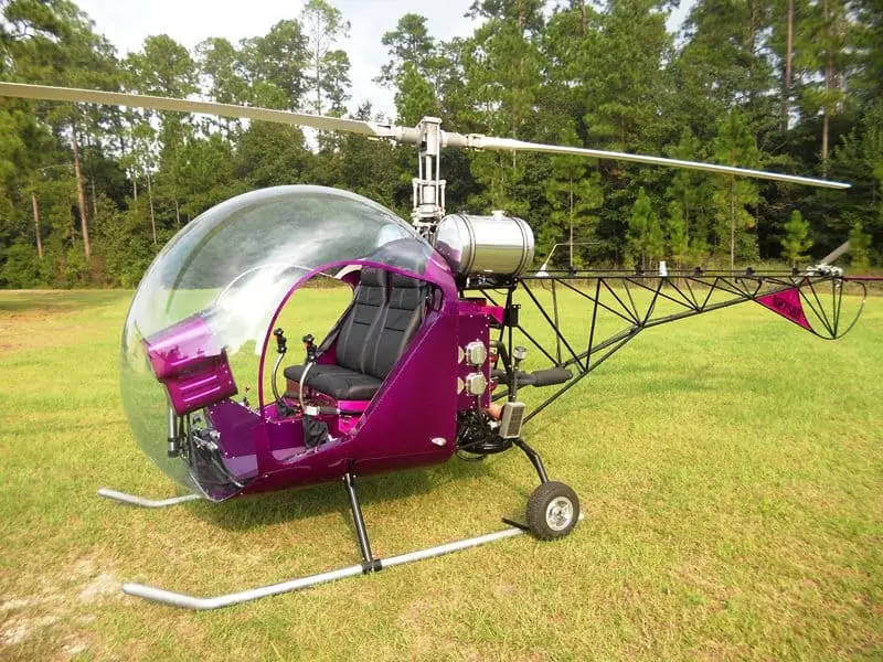 Magenta Safari 400 helicopter parked on grass