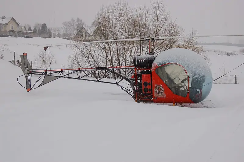 Red Safari 400 helicopter on snow-covered ground in Russia